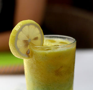 Yellow Juice in a glass with lemon